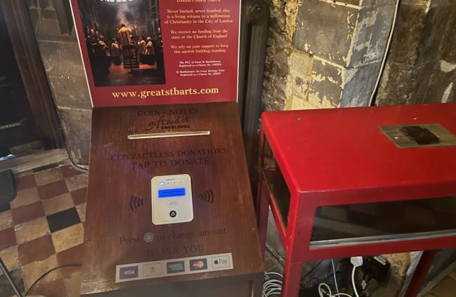 A close up of the contactless giving machine in St Barts church London
